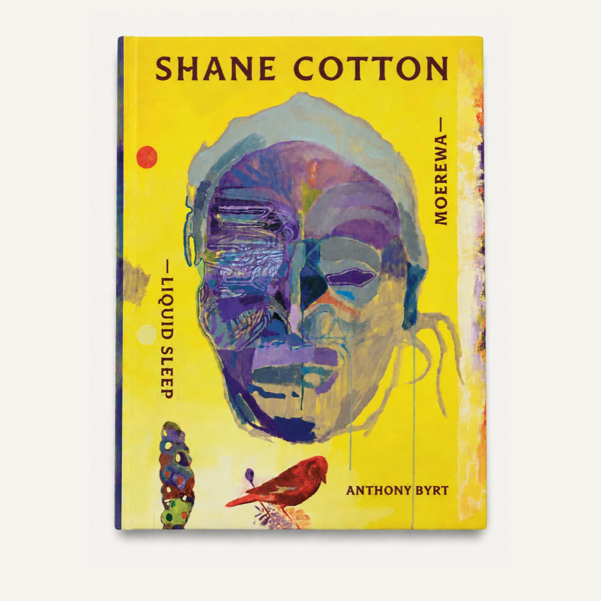 The book cover of 'Liquid Sleep: Shane Cotton - Moerewa' by Anthony Byrt, featuring a vibrant yellow background with an abstract painted face in purple, blue, and green tones, and a small red bird.