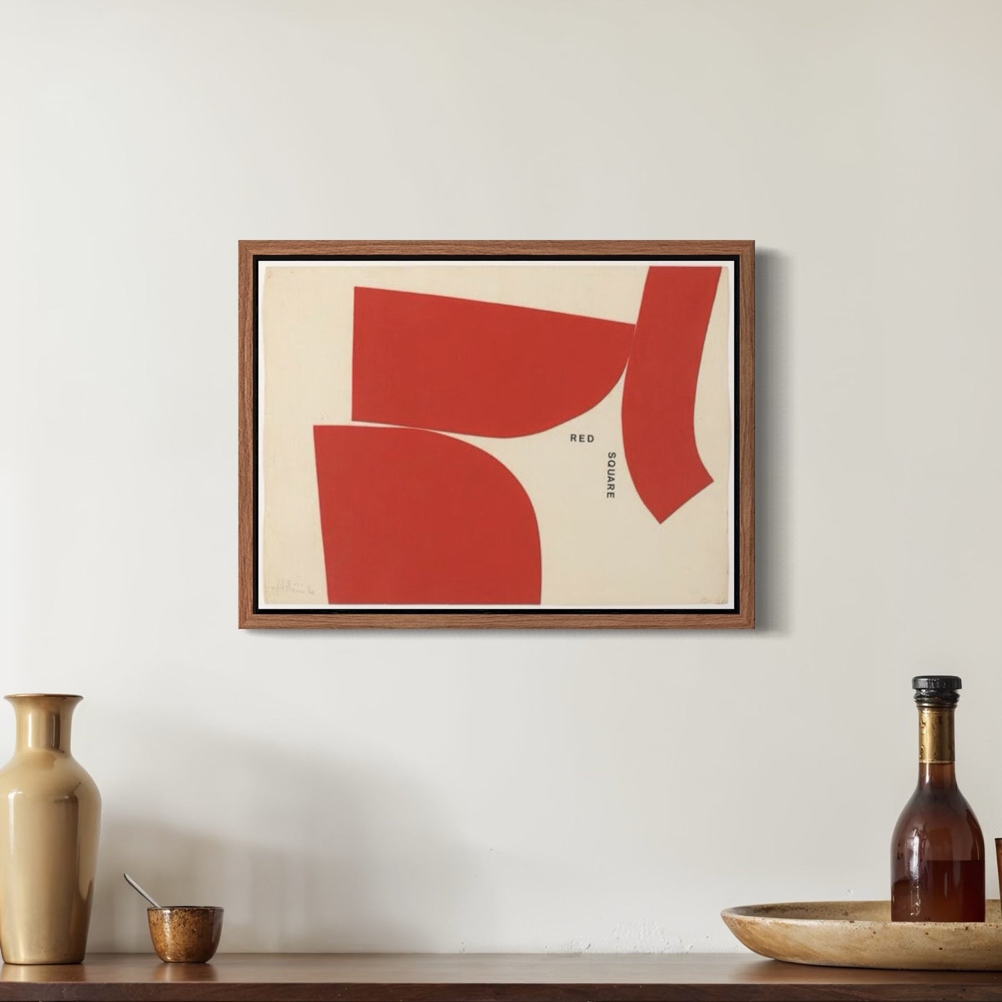 Hanging art print of abstract red geometric shapes on cream background