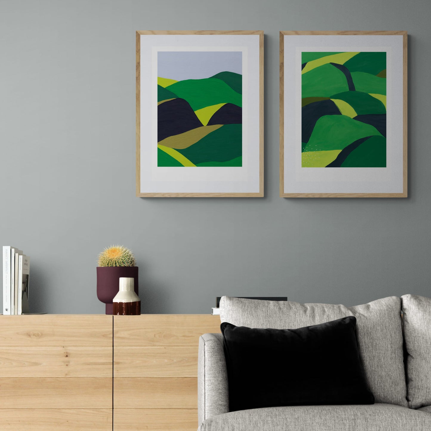 Two abstract landscapes hanging above sideboard