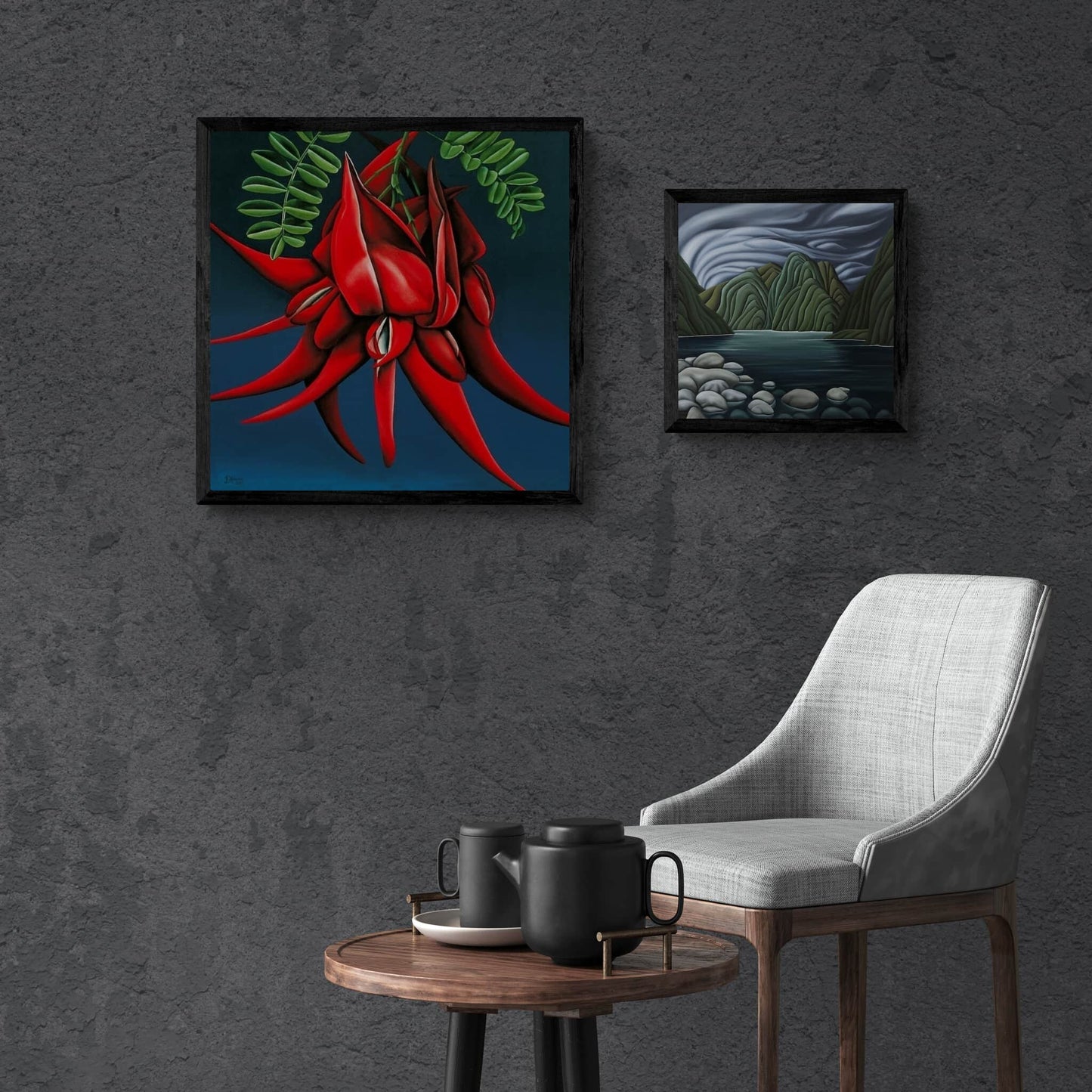 Two framed prints handing on dark grey wall.