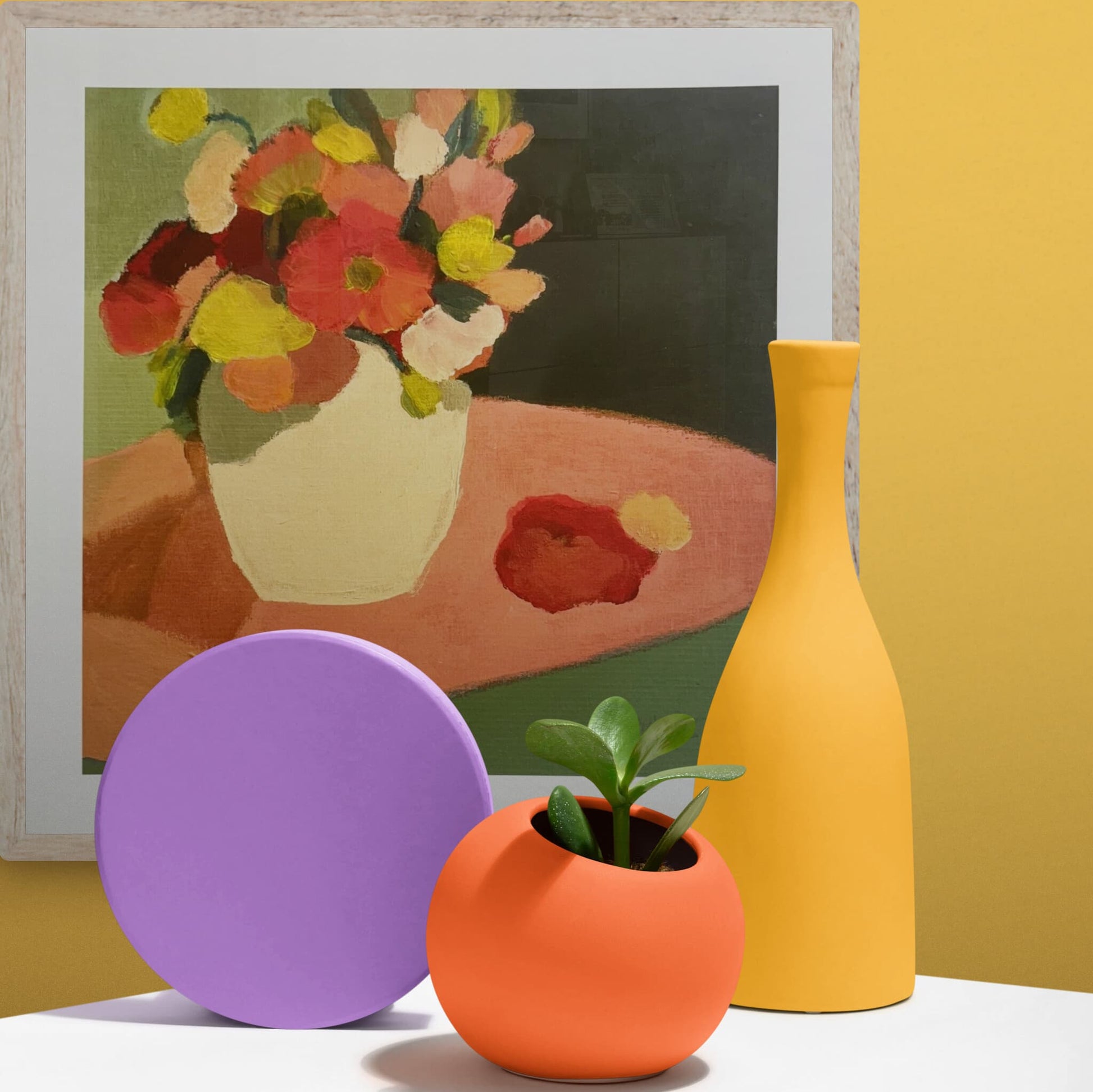"Spring Floral" print by Georgina Hoby Scutt, hanging on a bright yellow wall with brightly coloured ceramics.