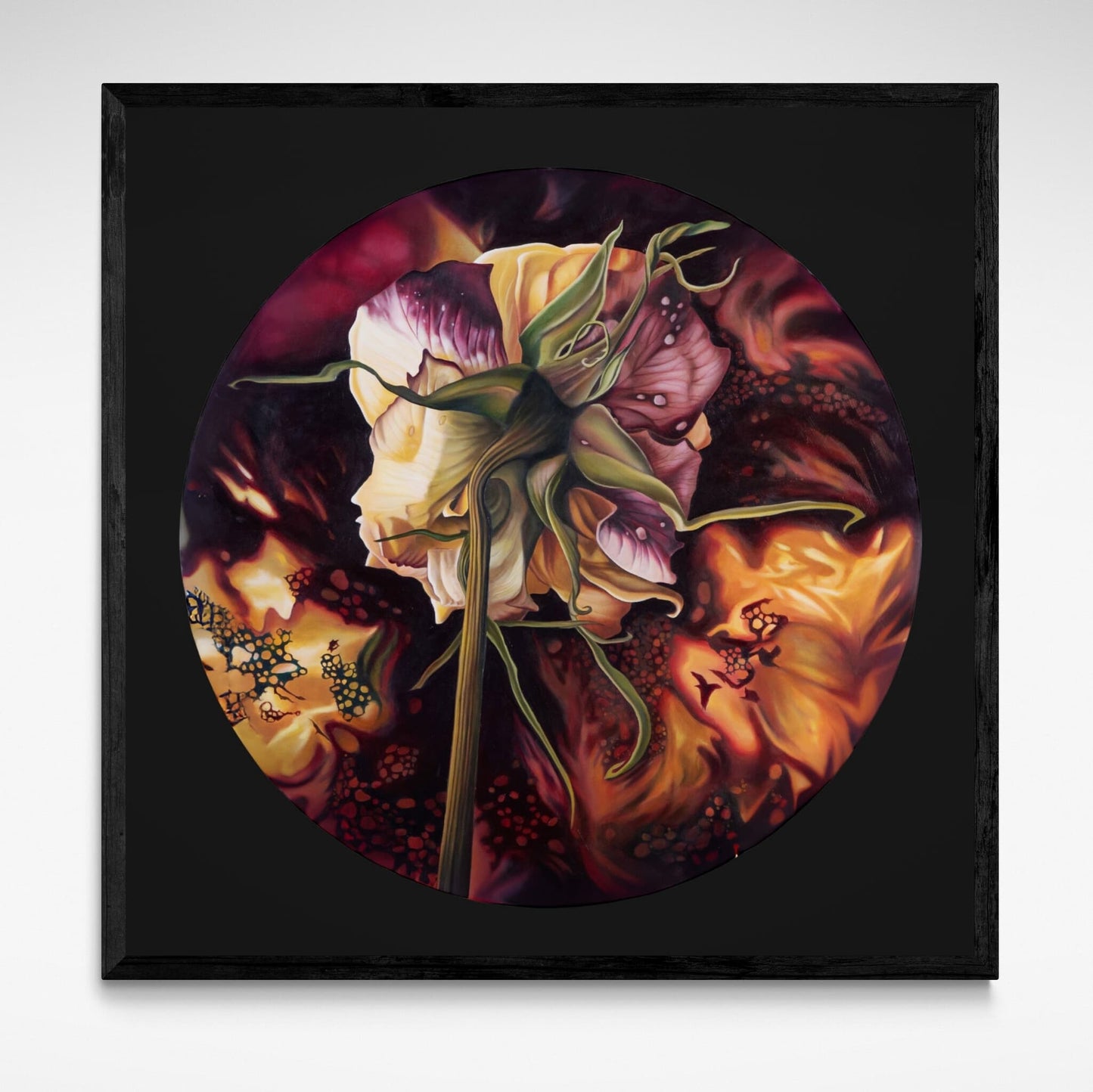 Framed artwork of a circular design with floral elements on a dark background