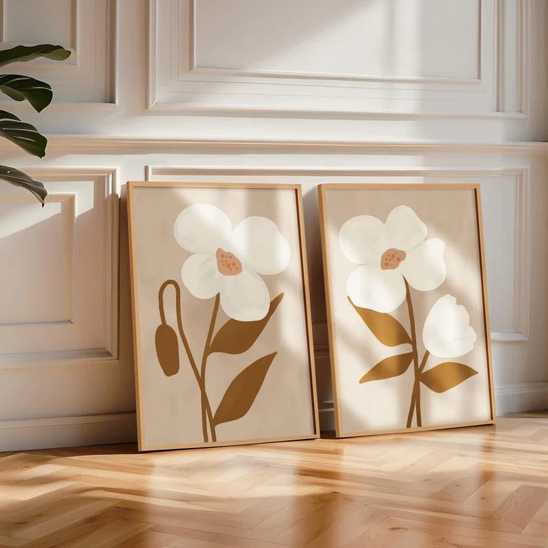 Neutral Flower Print and Minimal Flow Print by Solstice Studio Prints leaning against a white wall.