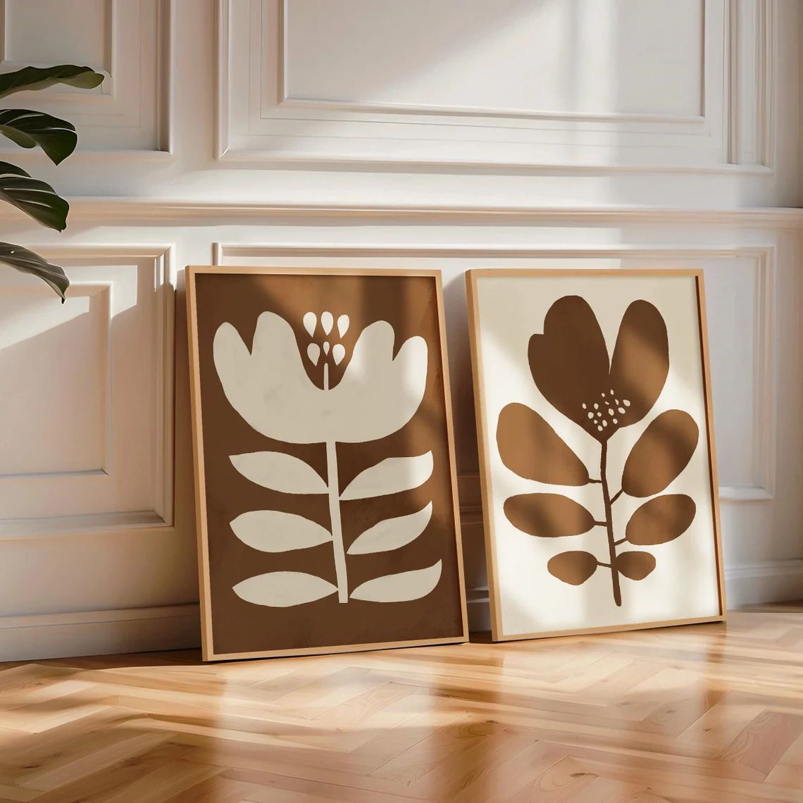 Two abstract floral and leaf prints, by Solstice Studio, in Mid-Century modern style, oversized retro flower wall art with white and tan accents.