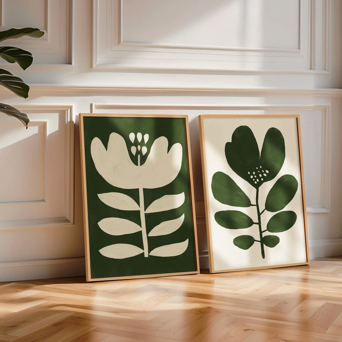 Two dark green oversized abstract floral and leaf prints by Solstice Studio, designed in Mid-Century modern style, featuring retro-inspired flower artwork.