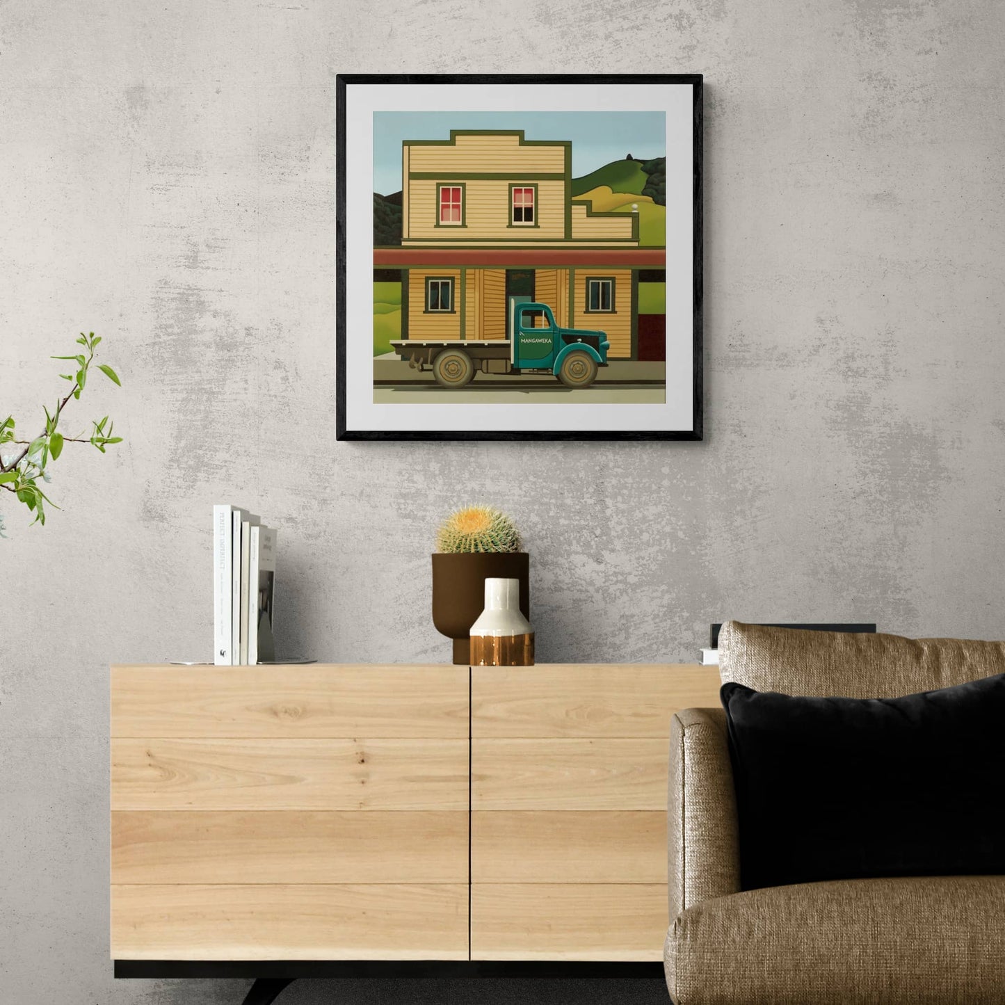 Framed and hanging print of old wooden building and green truck.