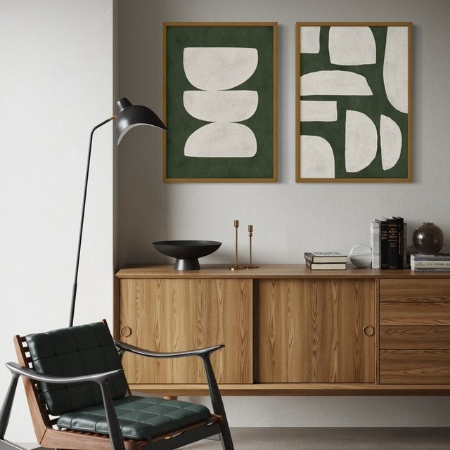 Modern interior with wooden sideboard, black chair, and abstract art prints by Solstice Studio Prints on the wall.