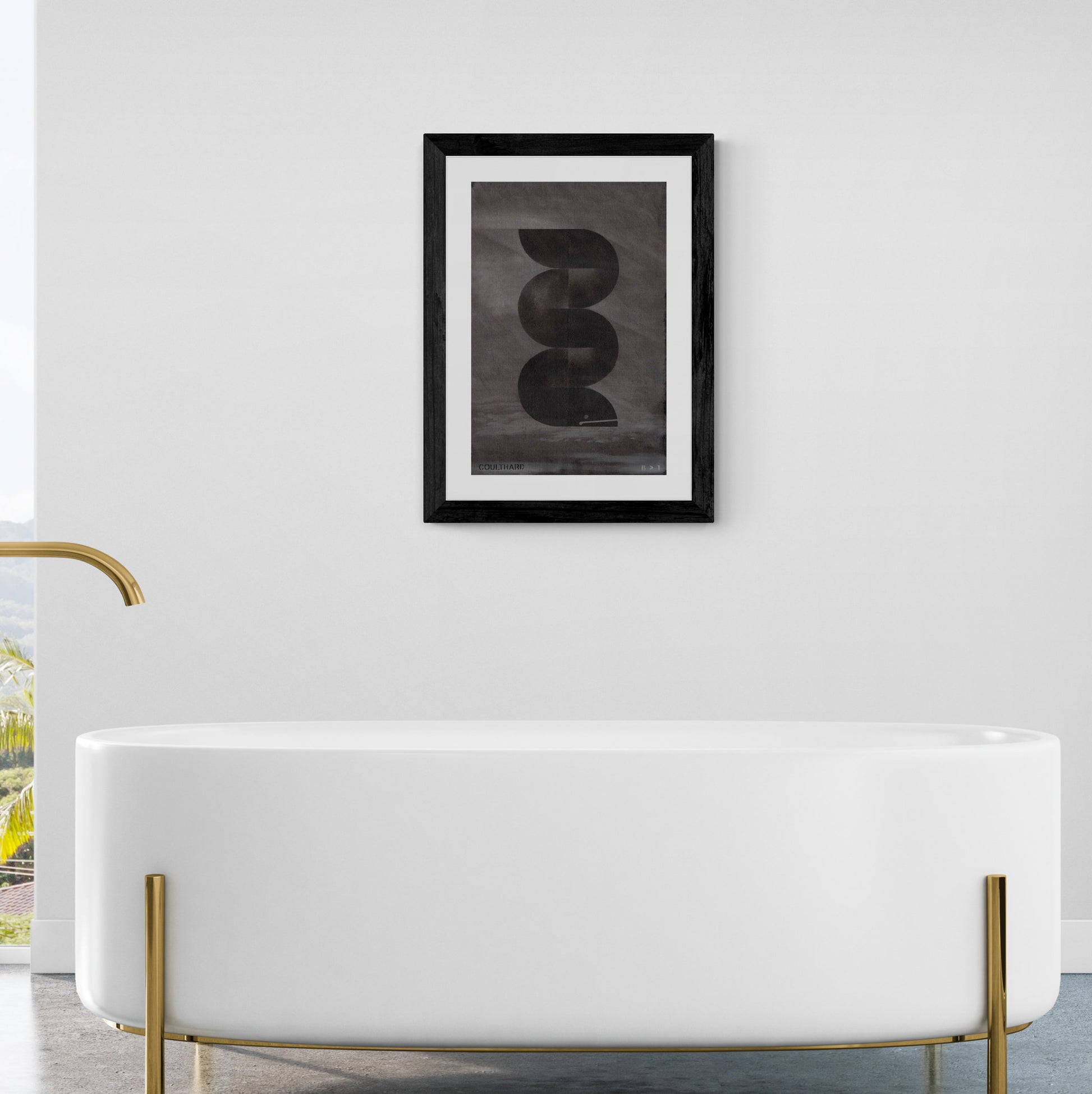Framed black and grey print of an eel hanging on wall in bathroom.
