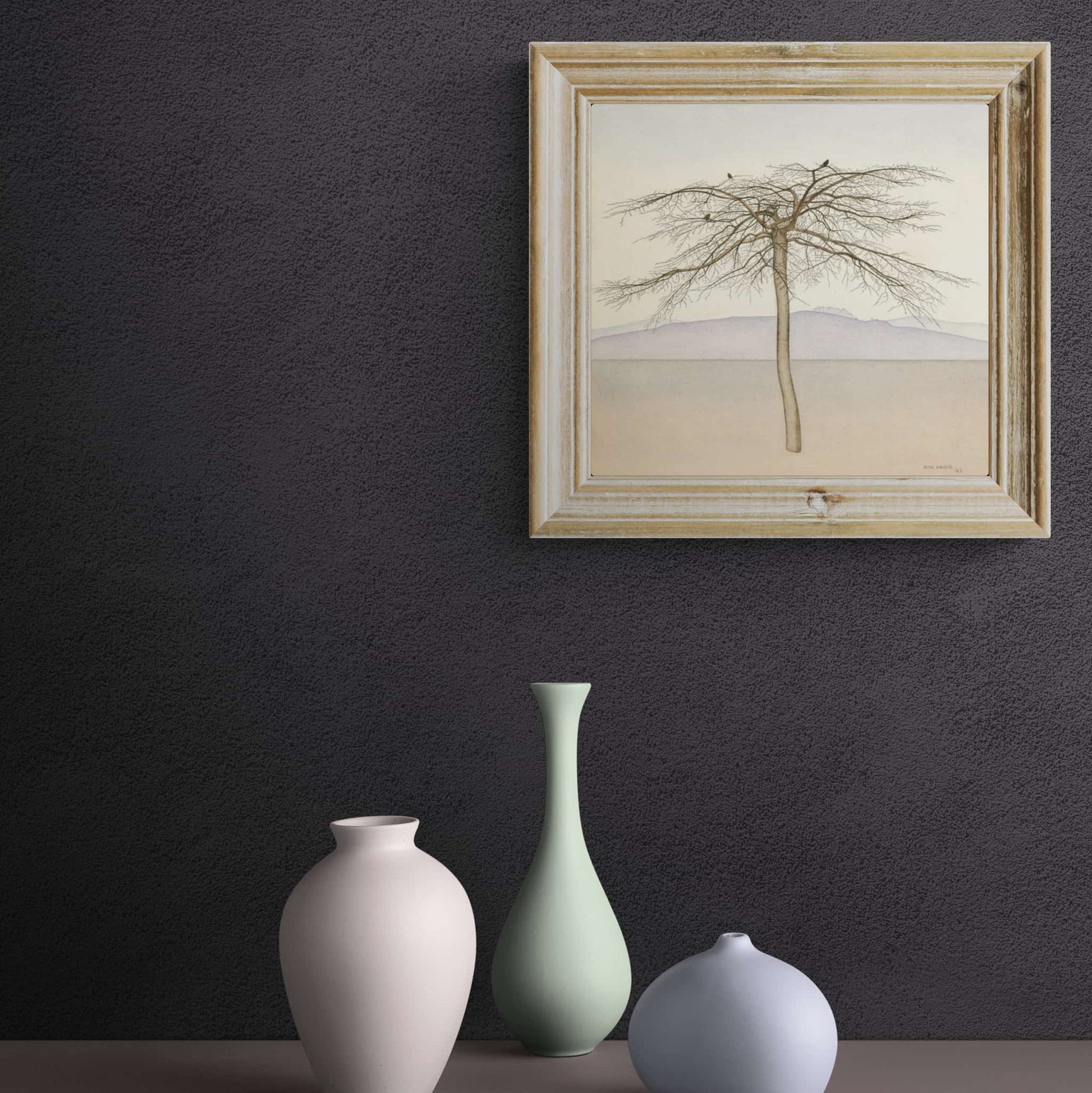 A framed and hanging ‘Tree’ by Rita Angus. A symbolic and iconic artwork depicting a solitary tree with stylized branches, set against a serene landscape.