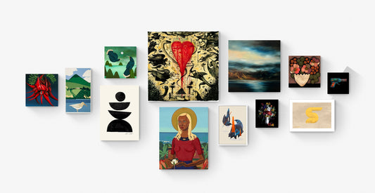 Grouping of art prints hanging on white wall.