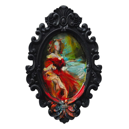 Decorative black frame with a colourful painting by Anita DeSoto of a woman in a red dress on a white background