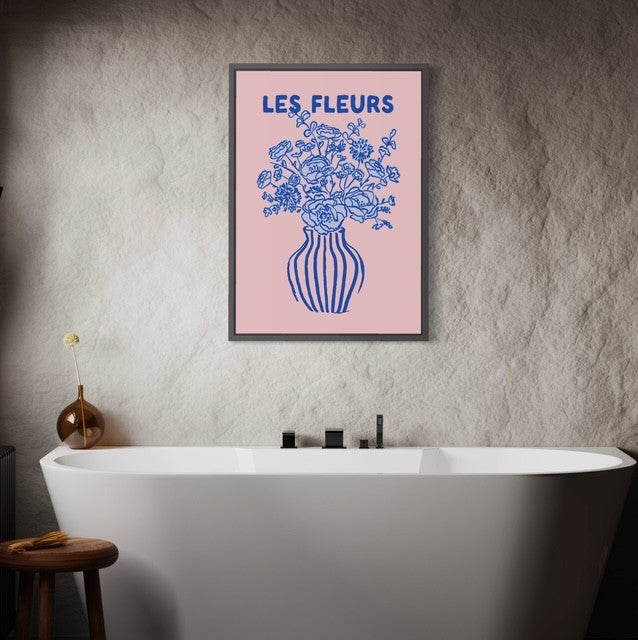 Framed artwork with floral design and 'LES FLEURS' text above a bathtub.
