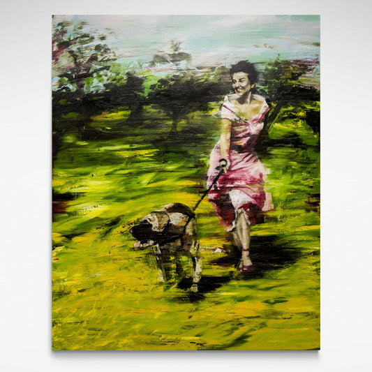 Woman running through golden grass with dog