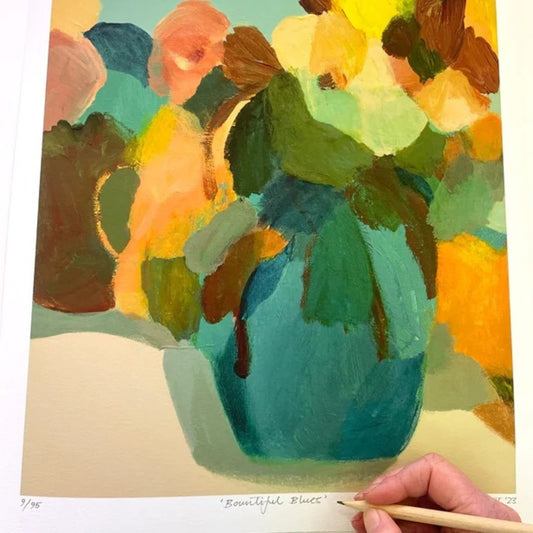 Abstract print blue vase with bright flowers, being signed by artist.