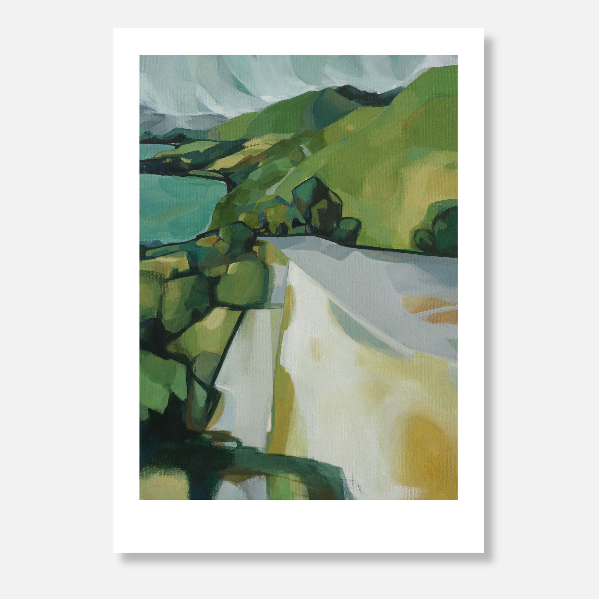 Landscape with green trees and a road running beside a lake.