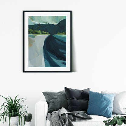 Limited edition art print titled "The Haast" by Holly Roach, depicting a stylized West Coast landscape displayed on a white wall above a couch..
