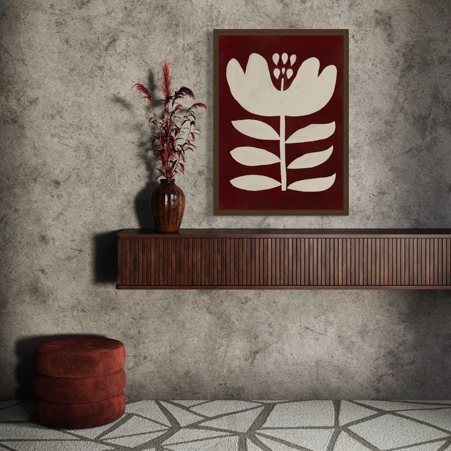 Decorative wall shelf with a vase and abstract floral artwork against a textured wall.
