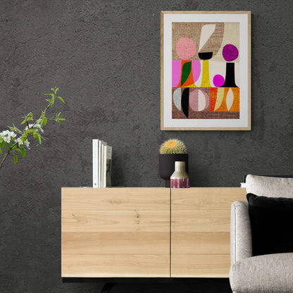 Framed colourful abstract print hanging above sideboard