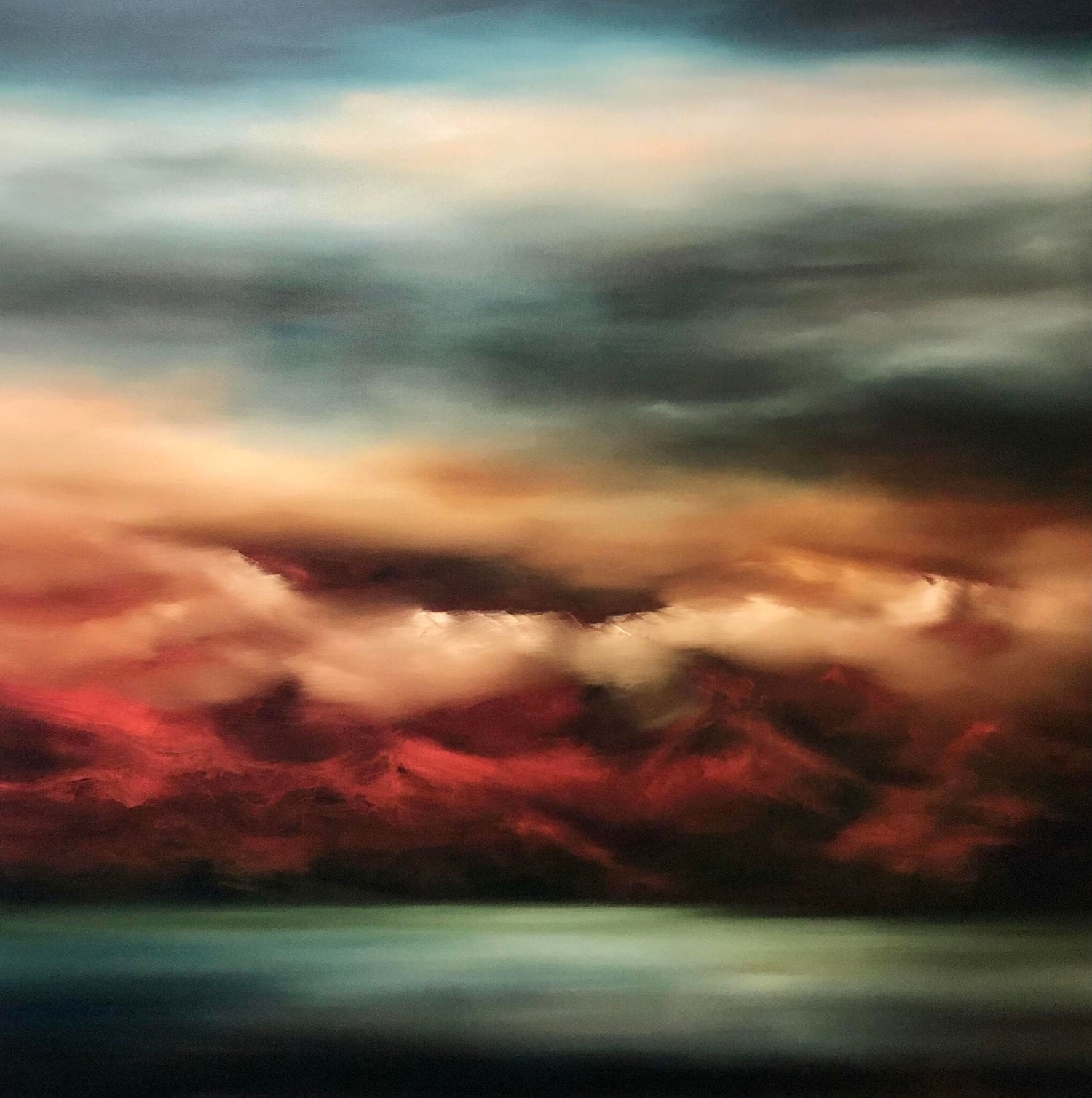 Cropped print of view across bay to a mountain range at Sunset with rich reds, blues and greens.