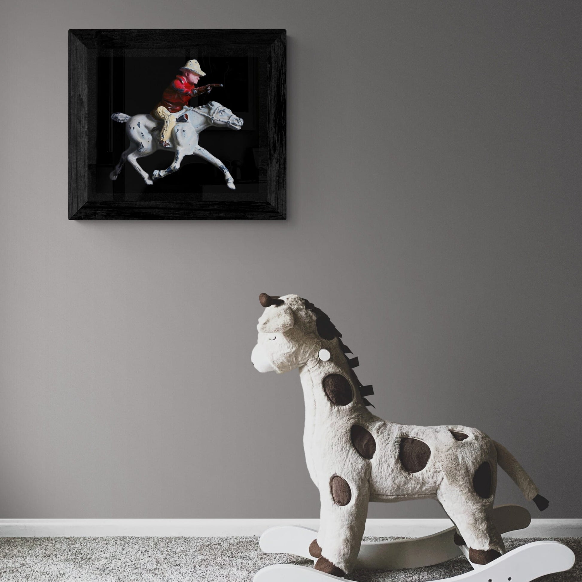 Print of old lead toy cowboy on horse hanging on wall