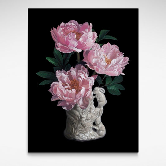 White ceramic vase with two bunnies on one side and three pink flowers arranged.