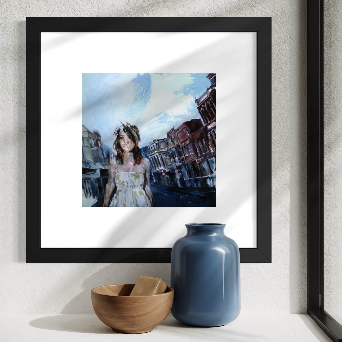 A framed art print featuring Justine Turnbull's Departure Point limited edition print of a woman on Cuba Street in Wellington