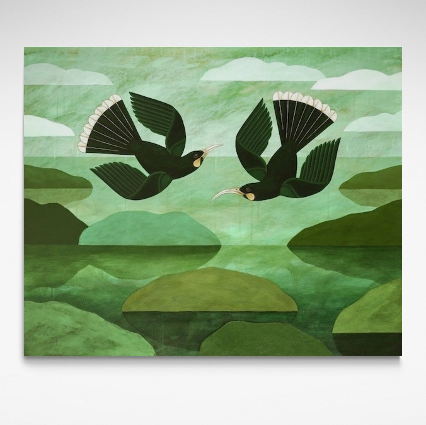 Two Huia flying in a green landscape