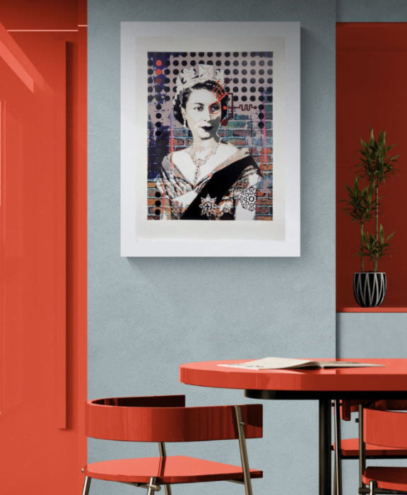 Dining area with red chairs and table against a gray wall with a framed screenprint by Brad Novak of Queen Elizabeth