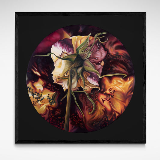 Framed artwork of a circular design with floral elements on a dark background