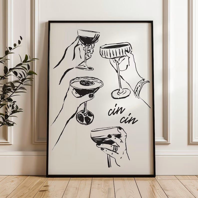 A vibrant black and white poster leaning against a white wall, featuring the playful phrase "Cin Cin" by Solstice Studio Prints.