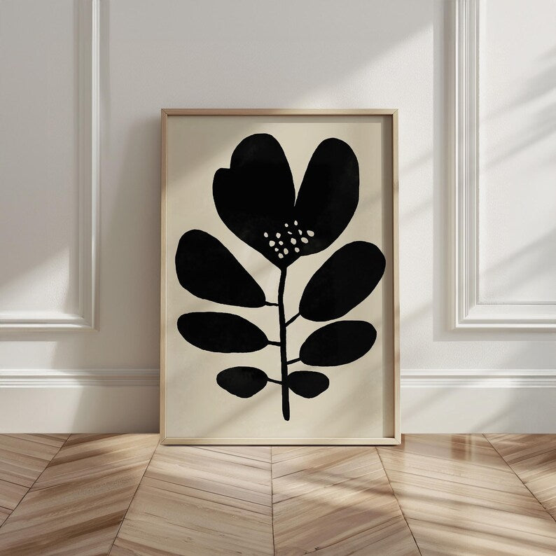 Oversized Black and White leaf print featuring an abstract floral design, leaning against a wall.