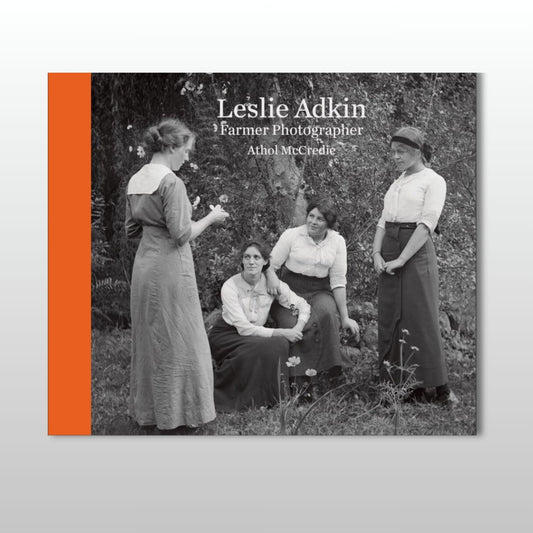 Book cover with black and white photo of women outdoors and orange spine.
