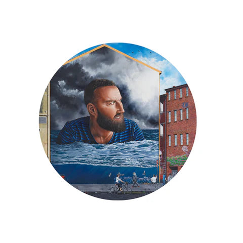 Self portrait of NZ artist Jeremy McCormick in a blue striped shirt, surrounded by water and a cityscape.