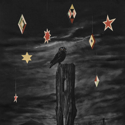 Dark surreal artwork, Nocturnal by Paula Coulthard, showing a black ruru perched on a weathered wooden post against a cloudy night sky, with hanging geometric and star-shaped ornaments in cream, red, and gold.
