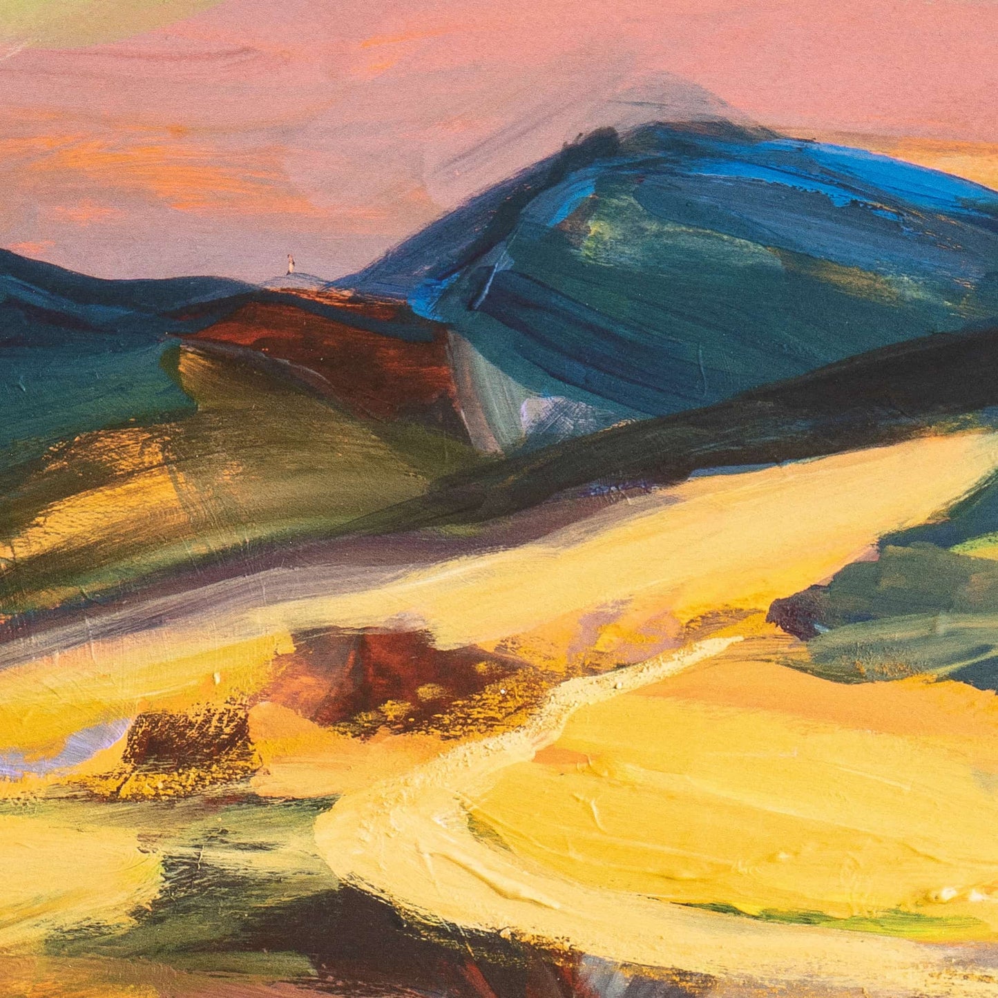 Closeup of colourful evening landscape print in yellow and gold with blue hills and pink sky.