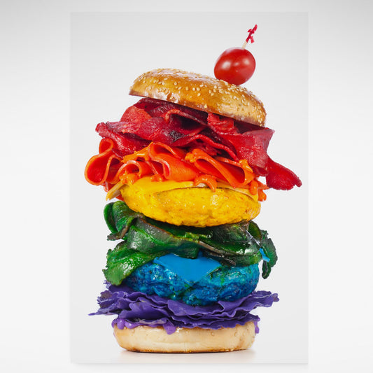 Print of burger rainbow coloured layers and tomato on top.