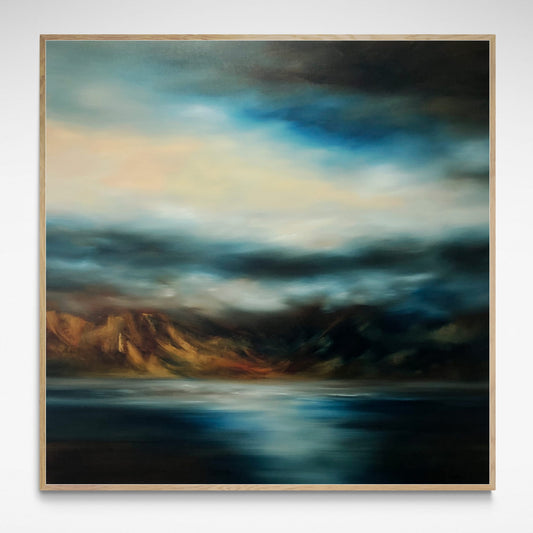 Framed landscape  print of sea, mountains and sky in moody blues and browns. 