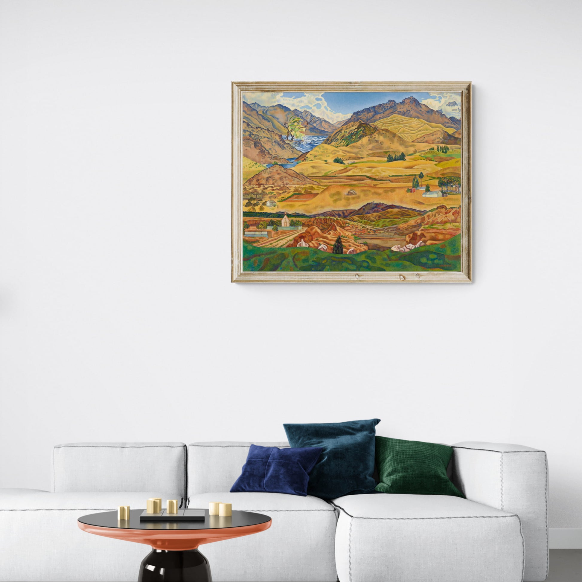 Abstract landscape print of Central Otago with bright yellow, green and blue hanging on wall above couch.